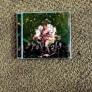 Melanie martinez portals CD. It is scratched on the front of the case. CD works.